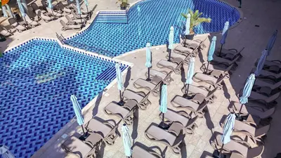 an overhead view of a large swimming pool with chairs at Best Western PLUS Premium Inn in Sunny Beach