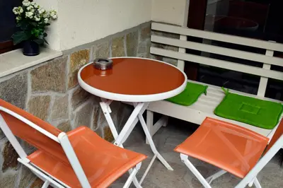 a table and two chairs sitting next to a window at Flora Beach Apartaments in Burgas City