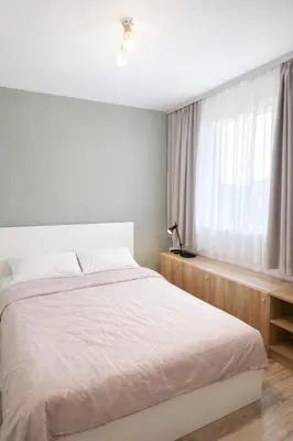 a bedroom with a white bed and a window at Maisonette Sevastiyan in Varna City