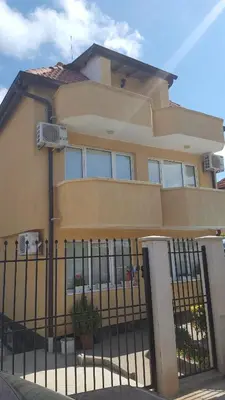 a house with a fence in front of it at Villa Krisia Apartments in Sozopol