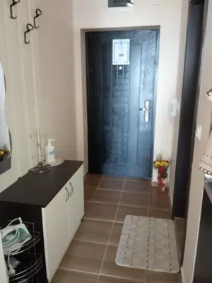 a bathroom with a black door and a tile floor at Apartment Bliznaci in Pomorie