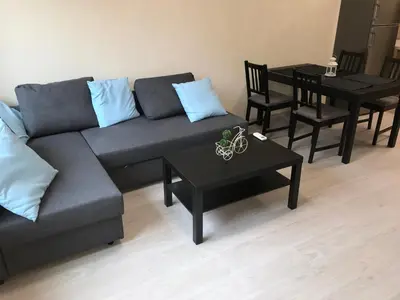 a living room with a couch and a table at Beach Apartments Pomorie in Pomorie