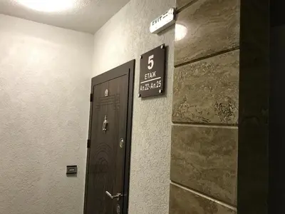 a door in a room with a sign on the wall at Beach Apartments Pomorie in Pomorie