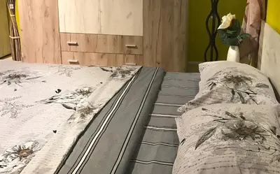 a bed with two pillows on top of it at Beach Apartments Pomorie in Pomorie