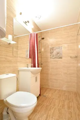 a bathroom with a toilet and a sink and a shower at Central studio 1 in Burgas City