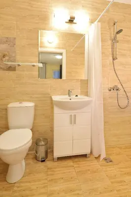 a bathroom with a toilet and a sink and a shower at Central studio #2 in Burgas City