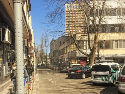 a city street with cars parked on the street at Central studio #2 in Burgas City
