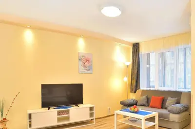 a living room with a tv and a couch at Central studio #2 in Burgas City