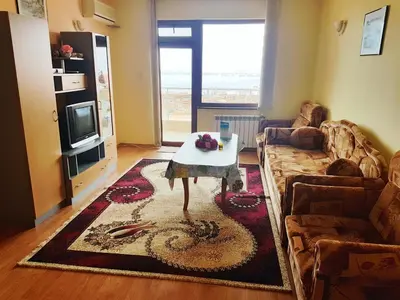a living room with a couch and a table at Guest House Byki in Sveti Vlas