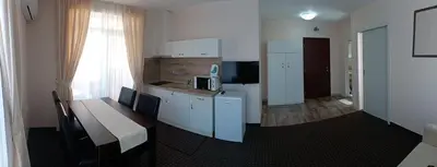 a room with a table and a kitchen with a table and a kitchen at Guest House SG-BROTHERS in Obzor