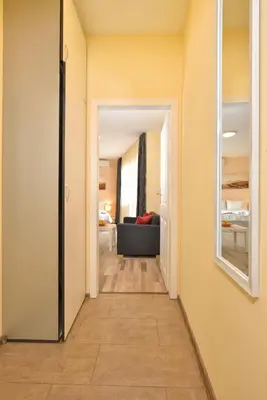 a hallway leading to a living room with a couch at Central studio #3 in Burgas City