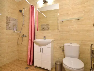 a bathroom with a toilet and a sink and a shower at Central studio #3 in Burgas City