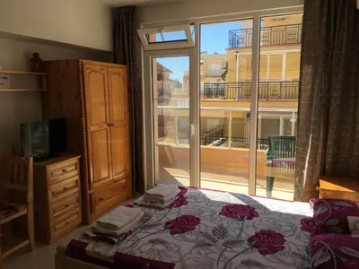 a bedroom with a bed and a large window at Studio Martin in Pomorie