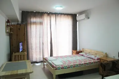 a bedroom with a bed and a large window at Studio Martin in Pomorie
