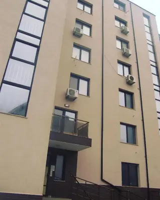 a tall building with windows and a balcony at Studio Sea Pearl in Pomorie