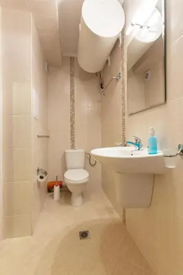a bathroom with a white sink and a toilet at Apartments Flora 1 in Burgas City