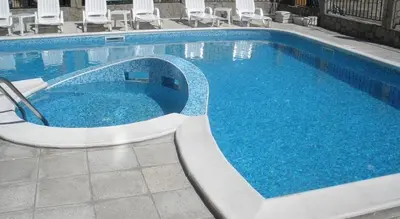 a swimming pool with blue water in a hotel at Abelia Residence Apartment Regina in Sunny Beach