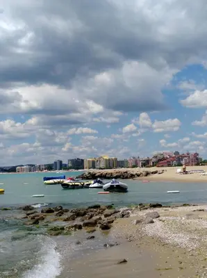a group of boats in the water near a beach at Harmony Suites Apartment in Sveti Vlas