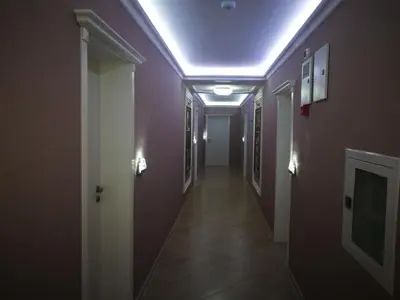 a hallway with purple walls and a hallway with a ceiling at Harmony Suites Apartment in Sveti Vlas