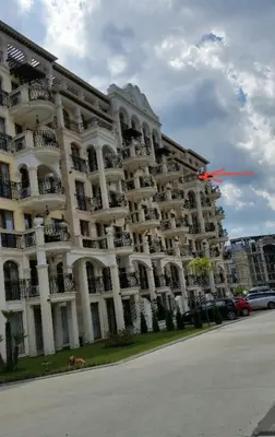 a red frisbee is flying in front of a building at Harmony Suites Apartment in Sveti Vlas