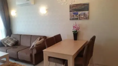 a living room with a couch and a table at Harmony Suites Apartment in Sveti Vlas