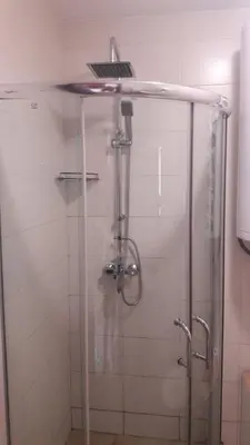 a shower with a glass door with a shower head at Alex Deluxe Apartments in Sunny Beach