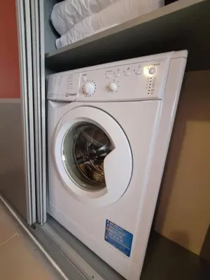 a white washing machine in a closet at Sirena Holidays in Ravda