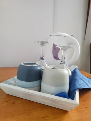 a tray with two dishes and glasses on a table at Guest Rooms Melsambria in Nesebar