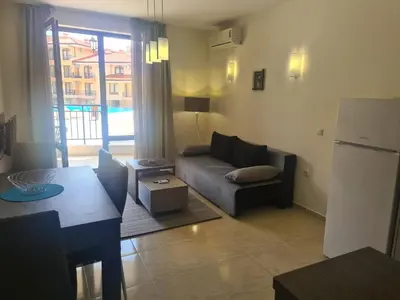 a living room with a couch and a table at Private Apartment in Star Dreams Complex in Sveti Vlas