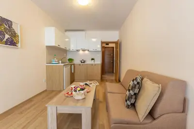 a living room with a couch and a table at Apartments Flora in Burgas City