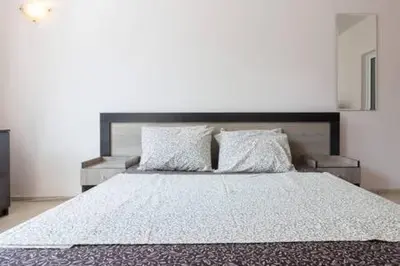 a bedroom with a large bed with two pillows at Santa Sofia Studio in Sunny Beach