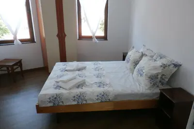 a bedroom with a bed with towels on it at Aleksandrovo Apartments in Aleksandrovo
