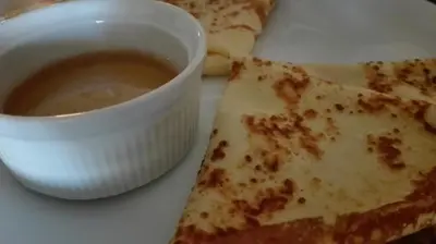 a plate of food with a bowl of soup and a piece of pizza at St Anastasia Hotel in Burgas City