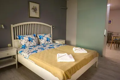 a bedroom with a bed with towels on it at Studios Grace - Port Tsarevo in Tsarevo