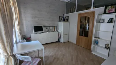a room with a kitchen with a refrigerator and a table at Apartments Iris69 in Varna City