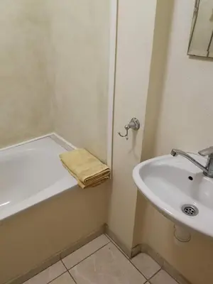 a bathroom with a sink and a bath tub next to a sink at Apartments Iris69 in Varna City