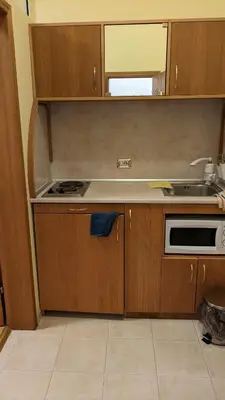 a kitchen with a sink and a stove top oven at Apartments Iris69 in Varna City