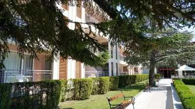 a row of benches in front of a building at DIT Evrika Beach Club Hotel - All Inclusive in Sunny Beach