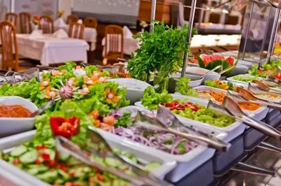 a buffet with many plates of food and salads at DIT Evrika Beach Club Hotel - All Inclusive in Sunny Beach