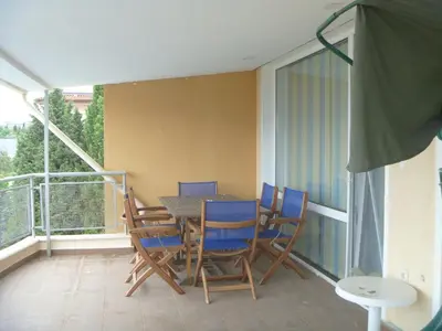 a room with a table and chairs on a balcony at Apartments Lucky Complex Ravda in Ravda