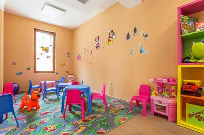 a classroom with tables and chairs in a room at Festa Via Pontica in Pomorie