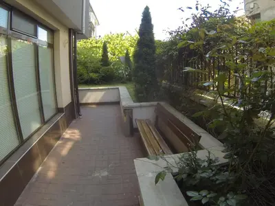a walk way with a bench and a building at Holidays apartment Bourgas in Burgas City
