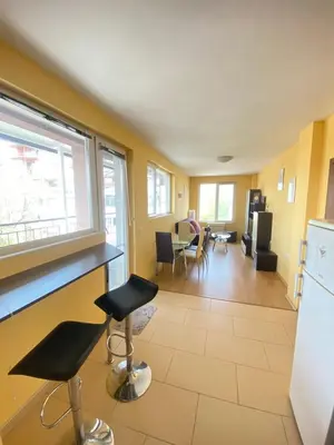 a kitchen and living room with a counter and chairs at Holidays apartment Bourgas in Burgas City