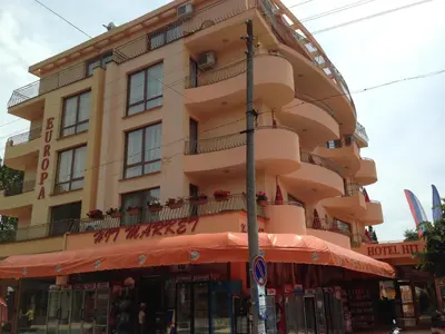 a large building with a store in front of it at Family Hotel Hit in Kiten