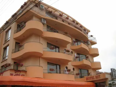 a large building with balconies and flowers on it at Family Hotel Hit in Kiten