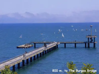 a pier in the ocean with boats on the water at 4U Apartment - Gurko in Burgas City