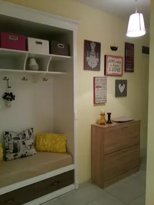 a bedroom with a bed and a dresser in a room at Florata apartment in Burgas City