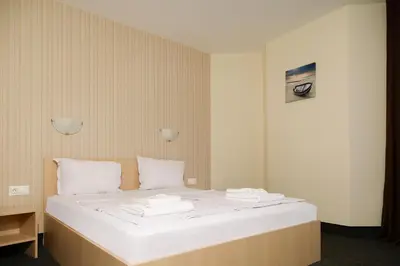 a bedroom with a bed with towels on it at Lozenets View Hotel in Lozenets