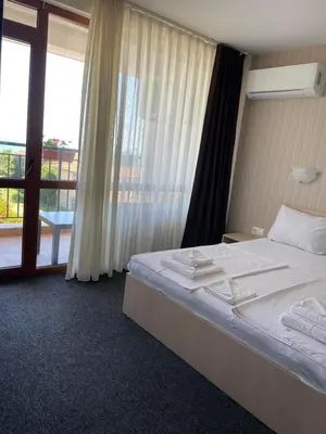 a hotel room with a bed and a large window at Lozenets View Hotel in Lozenets