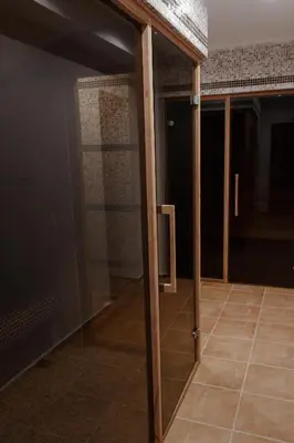 a glass door in a room with a tile floor at Lozenets View Hotel in Lozenets